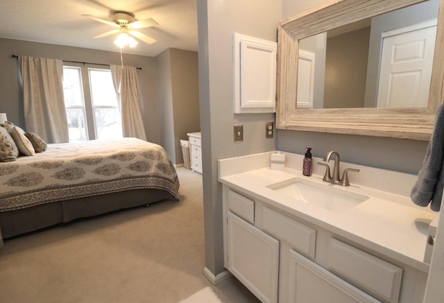 carpeted bedroom featuring sink and ceiling fan