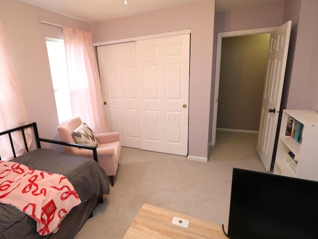 carpeted bedroom with a closet