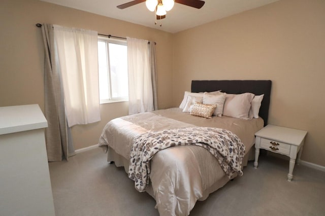 bedroom with light carpet and ceiling fan