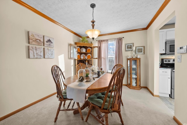 dining room featuring ornamental molding, light carpet, and a textured ceiling