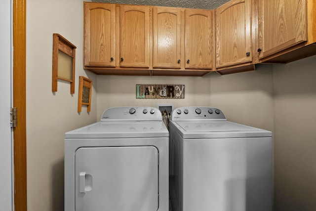 laundry room featuring cabinets and washing machine and dryer