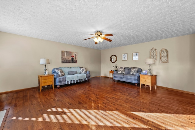 living room featuring hardwood / wood-style flooring, a textured ceiling, and ceiling fan