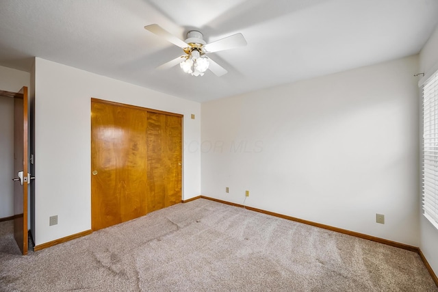 unfurnished bedroom with carpet floors, ceiling fan, and a closet