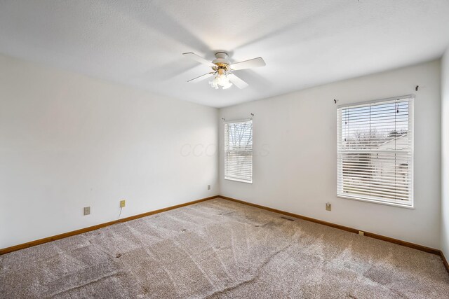 unfurnished room featuring carpet floors and ceiling fan