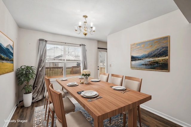 dining room featuring dark wood-type flooring and a chandelier