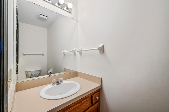 bathroom featuring vanity and toilet