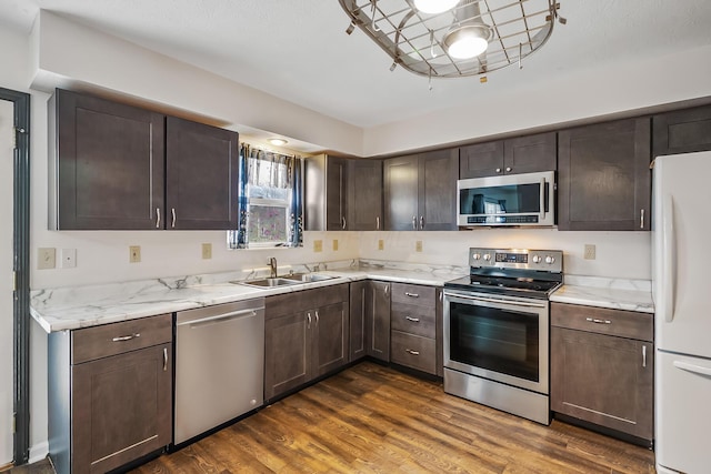 kitchen featuring appliances with stainless steel finishes, sink, and dark brown cabinetry