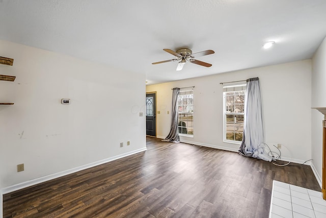 empty room featuring ceiling fan and dark hardwood / wood-style floors