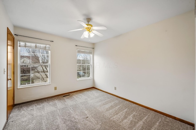 spare room featuring carpet flooring and ceiling fan