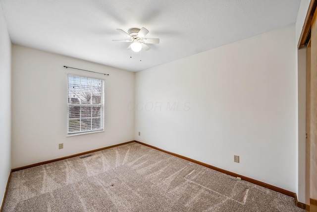 carpeted empty room with ceiling fan