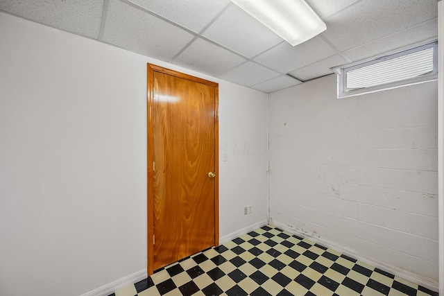 basement with a paneled ceiling