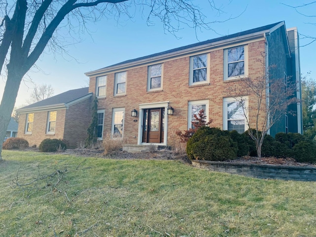 colonial home with a front lawn