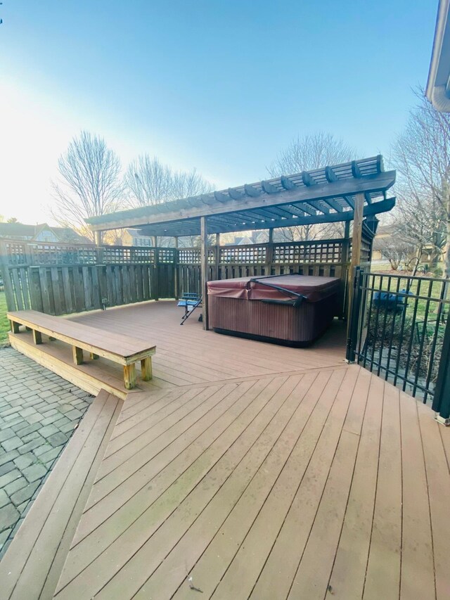 wooden terrace with a hot tub