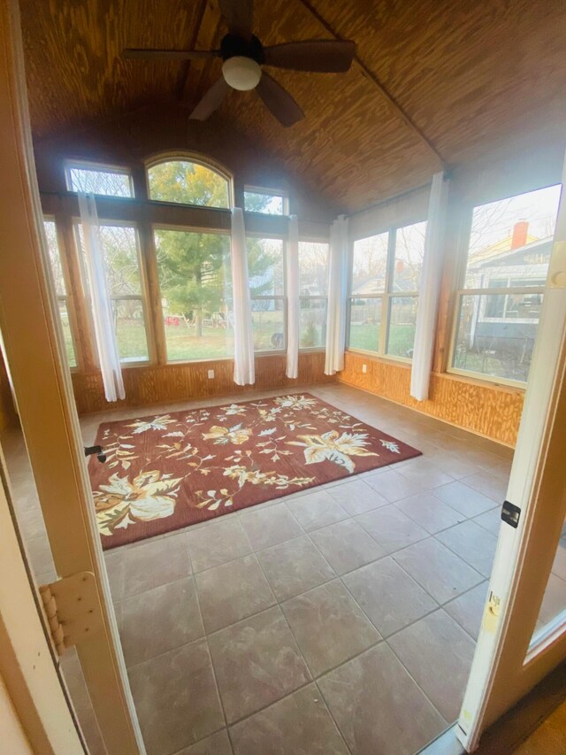 unfurnished sunroom featuring lofted ceiling, wooden ceiling, and ceiling fan