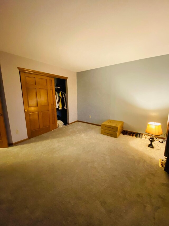 interior space with a closet and carpet flooring