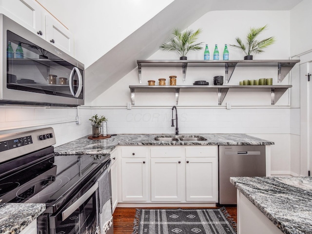 kitchen featuring sink, white cabinetry, tasteful backsplash, stone countertops, and appliances with stainless steel finishes