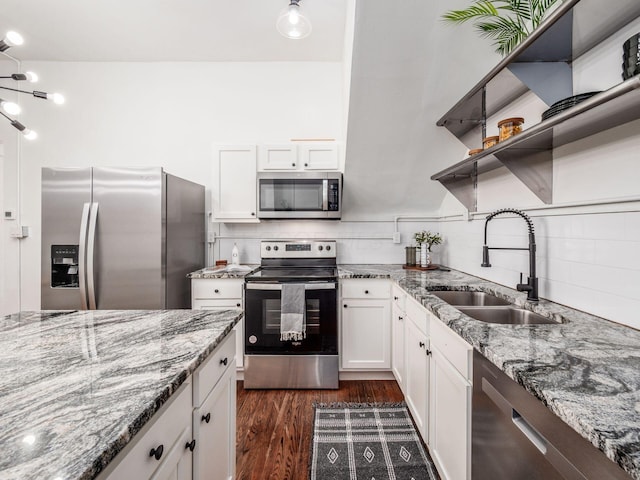 kitchen featuring dark wood-type flooring, sink, appliances with stainless steel finishes, light stone countertops, and white cabinets