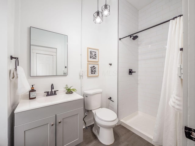 bathroom featuring hardwood / wood-style floors, vanity, toilet, and a shower with shower curtain