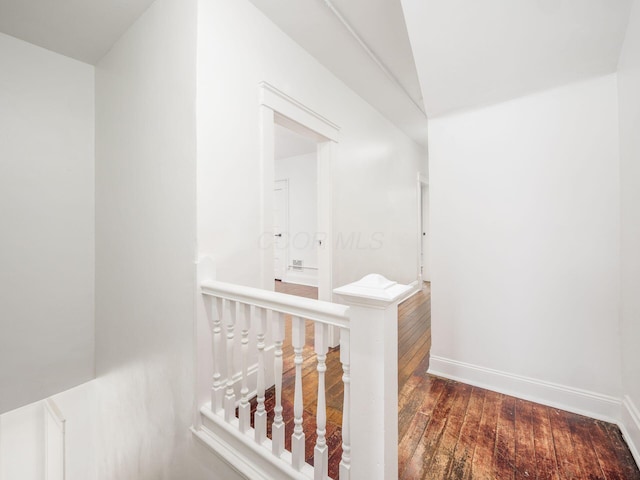 corridor with dark hardwood / wood-style flooring