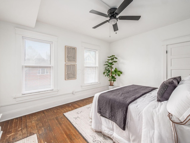 bedroom with ceiling fan and dark hardwood / wood-style floors