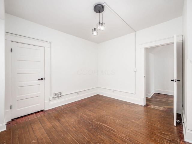 unfurnished room with dark hardwood / wood-style floors