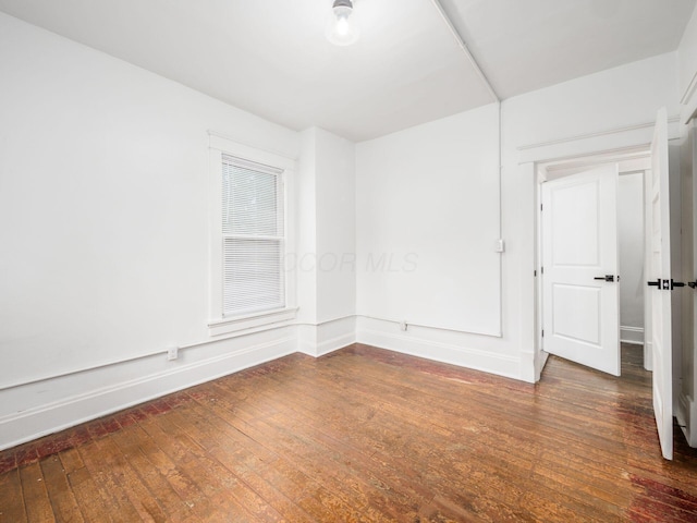 empty room featuring dark wood-type flooring