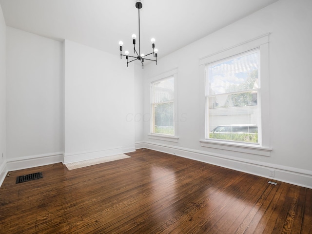 unfurnished dining area featuring a notable chandelier and wood-type flooring