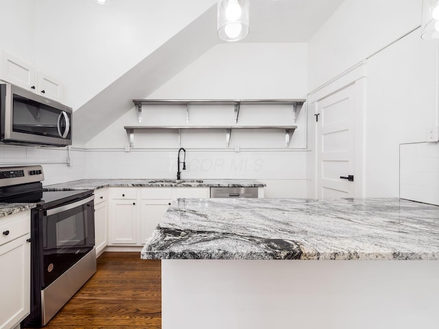 kitchen featuring appliances with stainless steel finishes, light stone countertops, sink, and white cabinets