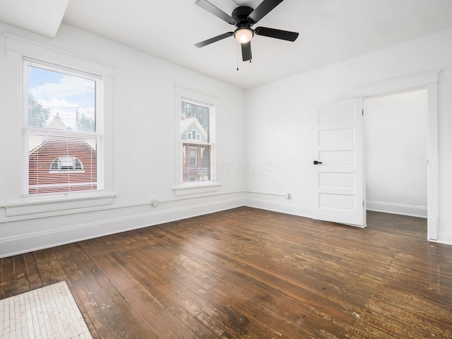 spare room featuring dark hardwood / wood-style flooring and ceiling fan