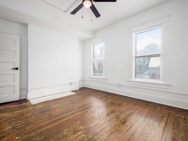 unfurnished room featuring ceiling fan, dark hardwood / wood-style flooring, and a wealth of natural light