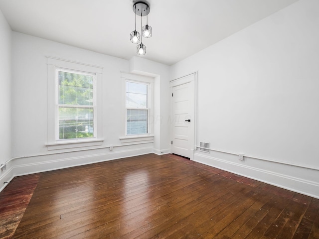 spare room featuring dark wood-type flooring