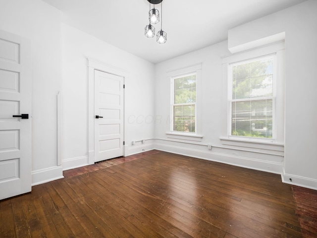 empty room with dark hardwood / wood-style flooring