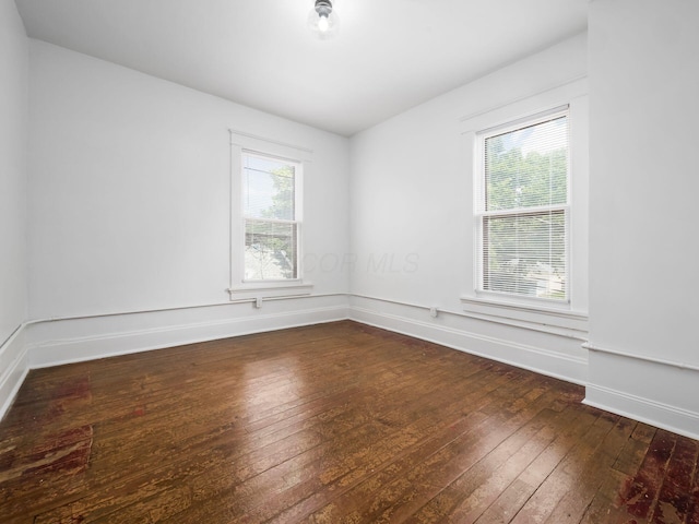 spare room featuring dark wood-type flooring