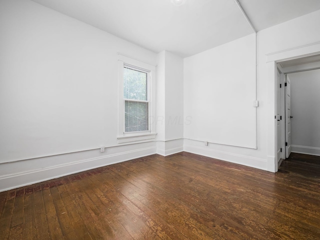 empty room featuring dark hardwood / wood-style flooring