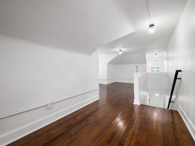 bonus room featuring lofted ceiling and dark hardwood / wood-style floors