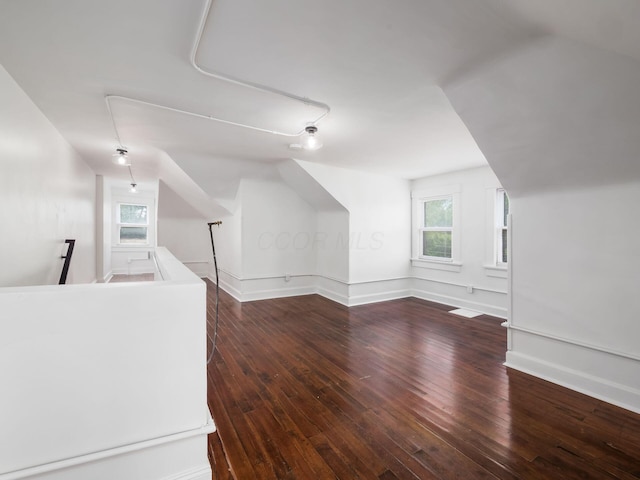 additional living space featuring dark hardwood / wood-style floors