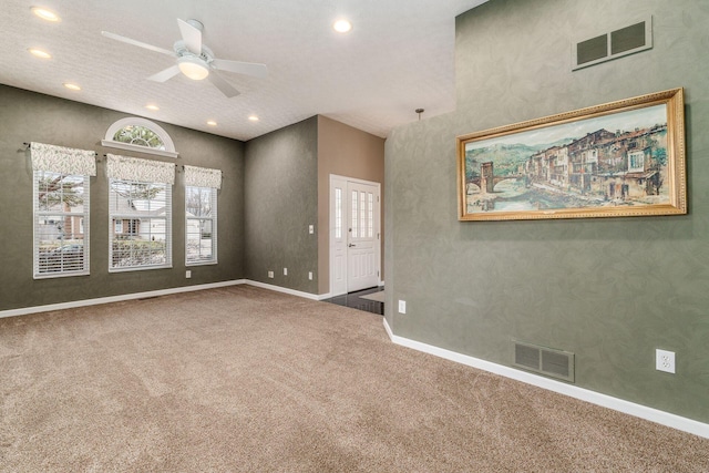 empty room with ceiling fan and carpet floors