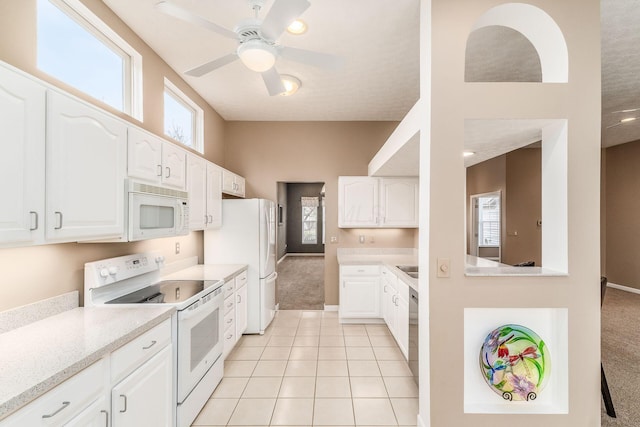 kitchen with ceiling fan, light tile patterned floors, white cabinets, and white appliances