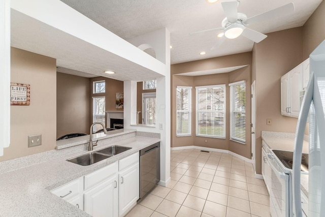 kitchen featuring sink, white electric range, dishwasher, light stone countertops, and white cabinets