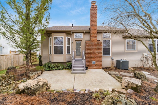 rear view of house with central AC and a patio area