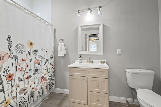 bathroom with vanity, toilet, and tile patterned flooring