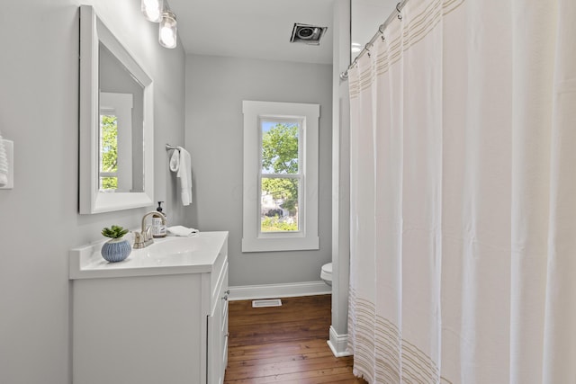 bathroom featuring hardwood / wood-style flooring, vanity, and toilet