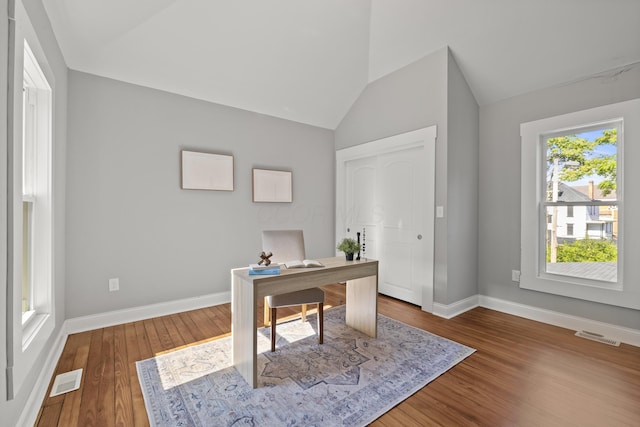 office area with hardwood / wood-style flooring and lofted ceiling