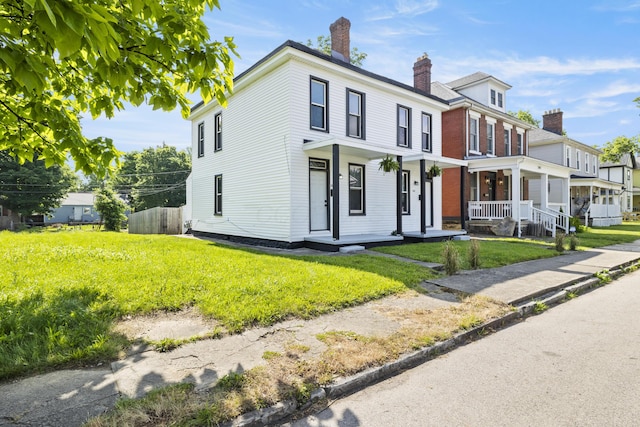 view of front of property featuring a porch and a front yard