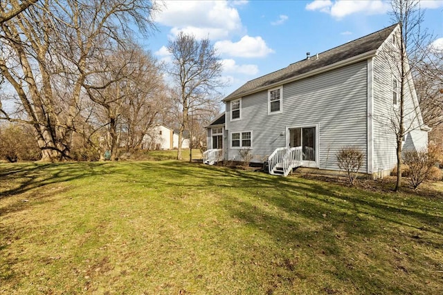 back of house with a lawn