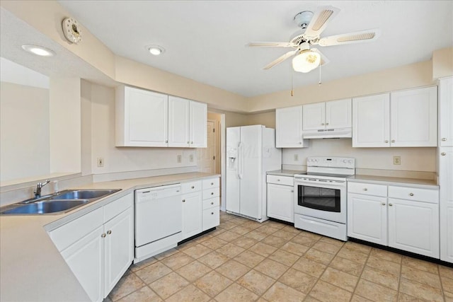 kitchen with white appliances, sink, and white cabinets