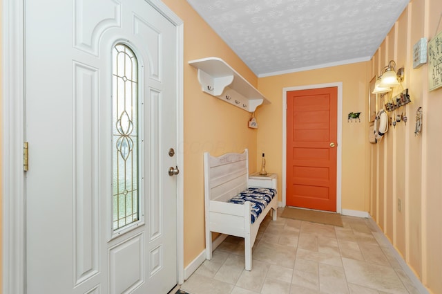 mudroom with light tile patterned flooring and a textured ceiling