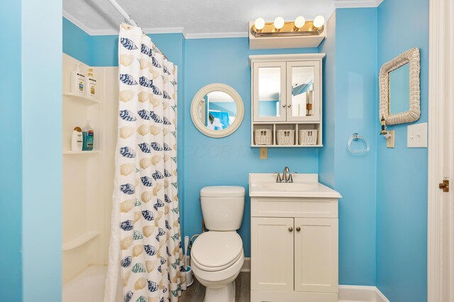 bathroom featuring crown molding, vanity, toilet, and curtained shower