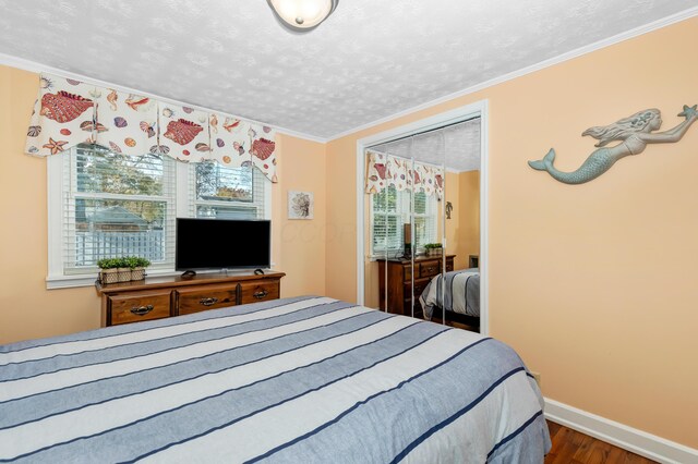 bedroom with crown molding, wood-type flooring, and a textured ceiling