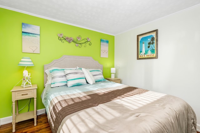 bedroom with crown molding and dark wood-type flooring